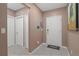 View of the entryway with neutral colored walls, white trim, and tile flooring at 14025 Canyon Swallow Rd, Weeki Wachee, FL 34614