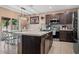 Spacious kitchen with stainless steel appliances, center island, and breakfast bar at 14025 Canyon Swallow Rd, Weeki Wachee, FL 34614