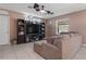 Comfortable living room featuring a large tv and ceiling fans at 14025 Canyon Swallow Rd, Weeki Wachee, FL 34614
