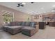 Open-concept living room and kitchen area with a large comfortable sofa at 14025 Canyon Swallow Rd, Weeki Wachee, FL 34614