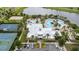Community clubhouse with multiple pools, a sand volleyball court, a basketball and a tennis court by the lake at 5528 Summer Sunset Dr, Apollo Beach, FL 33572