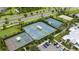 A dynamic aerial view of community sports facilities including tennis, pickleball, and basketball courts at 5528 Summer Sunset Dr, Apollo Beach, FL 33572