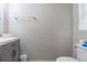 Bright bathroom featuring a modern gray vanity and a sleek chrome towel rack at 5528 Summer Sunset Dr, Apollo Beach, FL 33572