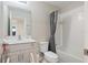 Well-lit bathroom featuring a single vanity, toilet, and shower-tub combination at 5528 Summer Sunset Dr, Apollo Beach, FL 33572
