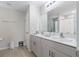 Bright bathroom showcasing double sinks with white cabinets and a large mirror at 5528 Summer Sunset Dr, Apollo Beach, FL 33572