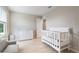 Charming Bedroom with white crib, dresser, and a comfortable grey chair at 5528 Summer Sunset Dr, Apollo Beach, FL 33572