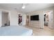 Light-filled bedroom showcasing wood floors, ceiling fan, and access to a large walk-in closet at 5528 Summer Sunset Dr, Apollo Beach, FL 33572