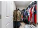 Walk-in closet with ample storage space and light hardwood floors at 5528 Summer Sunset Dr, Apollo Beach, FL 33572