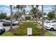 Professionally landscaped clubhouse with lush green plants and palm trees surrounded by a parking lot at 5528 Summer Sunset Dr, Apollo Beach, FL 33572