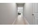 Hallway with light wood floors leading to the living area at 5528 Summer Sunset Dr, Apollo Beach, FL 33572