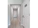 Neutral hallway featuring stylish plank flooring and white doors at 5528 Summer Sunset Dr, Apollo Beach, FL 33572