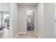 Hallway view of a bathroom featuring a grey vanity with step stool at 5528 Summer Sunset Dr, Apollo Beach, FL 33572