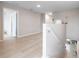 Bright hallway features light hardwood floors and neutral paint, creating a welcoming transition space at 5528 Summer Sunset Dr, Apollo Beach, FL 33572