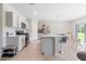 Modern kitchen with a center island, stainless steel appliances, and adjacent dining area at 5528 Summer Sunset Dr, Apollo Beach, FL 33572