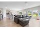 A modern living space showcases a comfortable sectional sofa open to the modern kitchen at 5528 Summer Sunset Dr, Apollo Beach, FL 33572