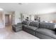 Spacious living area featuring a comfortable sectional sofa, open to the modern kitchen at 5528 Summer Sunset Dr, Apollo Beach, FL 33572