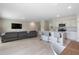 An open floor plan features a living room and kitchen with an island and bar seating at 5528 Summer Sunset Dr, Apollo Beach, FL 33572