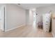 Neutral-toned room featuring light hardwood floors, providing a bright and versatile space at 5528 Summer Sunset Dr, Apollo Beach, FL 33572