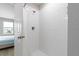 Clean and modern bathroom with a fully tiled shower and glass door at 5528 Summer Sunset Dr, Apollo Beach, FL 33572