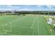 Aerial view of a sports field and parking lot with artificial turf and painted white lines for sports activities at 5528 Summer Sunset Dr, Apollo Beach, FL 33572