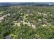An aerial view of a serene, verdant neighborhood surrounded by dense tree cover and a canopy of green at 39 Sunset Dr, Brooksville, FL 34601