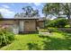 The backyard features lush green grass and a utility access door at 39 Sunset Dr, Brooksville, FL 34601