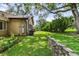 The backyard features lush green grass, garden beds, and a stone retaining wall at 39 Sunset Dr, Brooksville, FL 34601