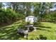 A stone picnic table and bench set offers a cozy spot in the backyard at 39 Sunset Dr, Brooksville, FL 34601