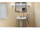 Powder room with pedestal sink, large mirror, and sconce lighting at 39 Sunset Dr, Brooksville, FL 34601