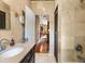 Modern bathroom with tiled walls, dark cabinets, and wood floors at 39 Sunset Dr, Brooksville, FL 34601