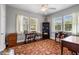 Light-filled bedroom with hardwood floors, multiple windows, and a ceiling fan at 39 Sunset Dr, Brooksville, FL 34601