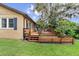 Spacious backyard deck with outdoor seating, steps to yard, and mature landscaping at 39 Sunset Dr, Brooksville, FL 34601