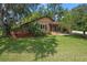 Charming bungalow with a lush lawn and inviting deck, perfect for relaxing outdoors at 39 Sunset Dr, Brooksville, FL 34601
