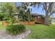 Charming home featuring a wooden ramp, lush landscaping, and a quaint birdbath in the front yard at 39 Sunset Dr, Brooksville, FL 34601