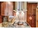 Elegant kitchen featuring granite counters, a stylish backsplash, and modern cooktop at 39 Sunset Dr, Brooksville, FL 34601