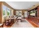 Cozy living room with hardwood floors, large windows, and an elegant entertainment center at 39 Sunset Dr, Brooksville, FL 34601