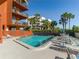 Community pool with plenty of lounge chairs at 15316 Gulf Blvd # 301, Madeira Beach, FL 33708