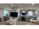 Modern kitchen with gray cabinets, stainless steel appliances, and herringbone floor at 15316 Gulf Blvd # 301, Madeira Beach, FL 33708