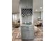 Kitchen with wine rack, granite countertop, and gray cabinets at 15316 Gulf Blvd # 301, Madeira Beach, FL 33708