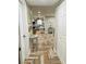 Entryway with herringbone floors and view into kitchen and dining area at 15316 Gulf Blvd # 301, Madeira Beach, FL 33708