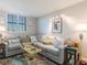 Living area featuring a grey sectional sofa and coastal decor at 15316 Gulf Blvd # 301, Madeira Beach, FL 33708