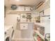 Bright laundry room with washer, dryer, and built-in shelving at 15316 Gulf Blvd # 301, Madeira Beach, FL 33708