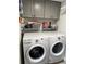 Laundry room with side-by-side Whirlpool washer and dryer at 15316 Gulf Blvd # 301, Madeira Beach, FL 33708