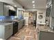 Open concept kitchen with gray cabinets, granite countertops, and herringbone floors at 15316 Gulf Blvd # 301, Madeira Beach, FL 33708