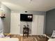 Bedroom with a TV, double doors, and herringbone floors at 15316 Gulf Blvd # 301, Madeira Beach, FL 33708