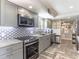 Modern kitchen with gray cabinets, stainless steel appliances, and granite counters at 15316 Gulf Blvd # 301, Madeira Beach, FL 33708