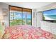 Main bedroom with ocean view and a large TV at 15316 Gulf Blvd # 301, Madeira Beach, FL 33708