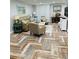 Bright living room with comfortable seating and stylish herringbone flooring at 15316 Gulf Blvd # 301, Madeira Beach, FL 33708