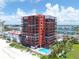Aerial view of beachfront condo building with pool at 15316 Gulf Blvd # 301, Madeira Beach, FL 33708