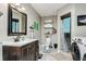 Bathroom with vanity, shower, toilet, and in-unit laundry at 6628 1St N St, St Petersburg, FL 33702